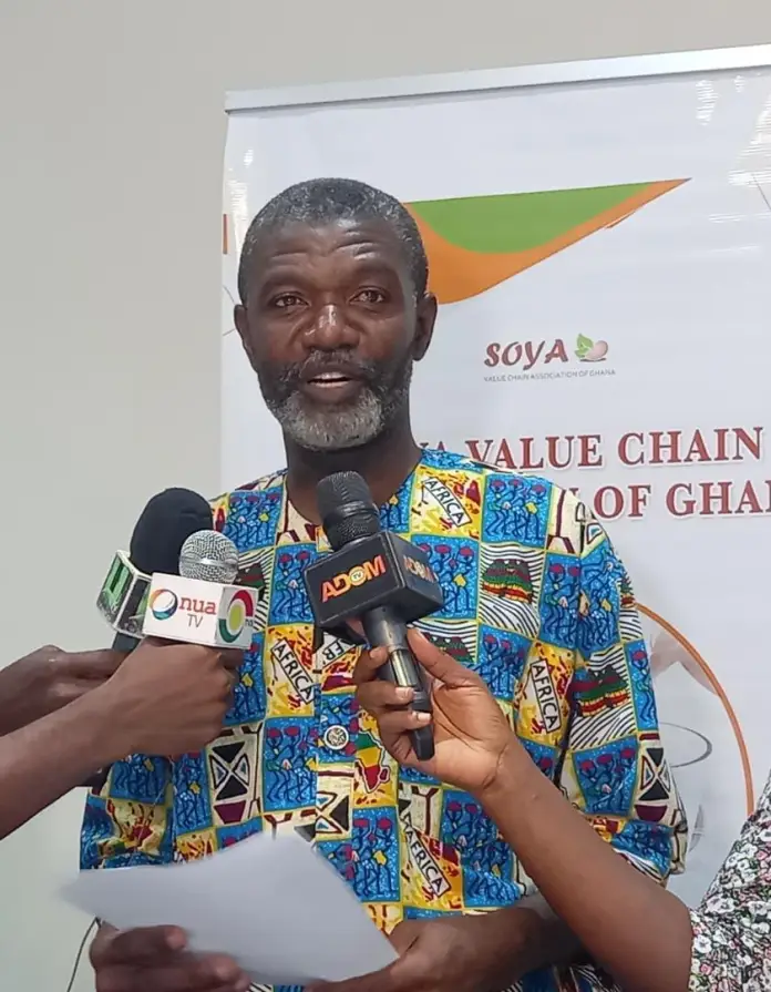 An SVCAG representative addressing the press beneath the association banner